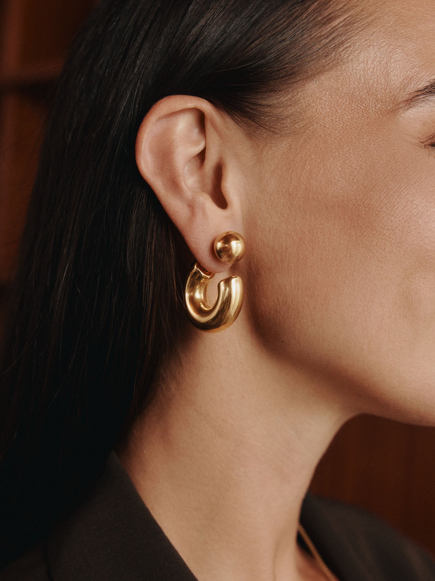 Roségoldene Creolen mit modernem Design, getragen von einer Frau, PURELEI. Elegante, feminine Ausstrahlung.